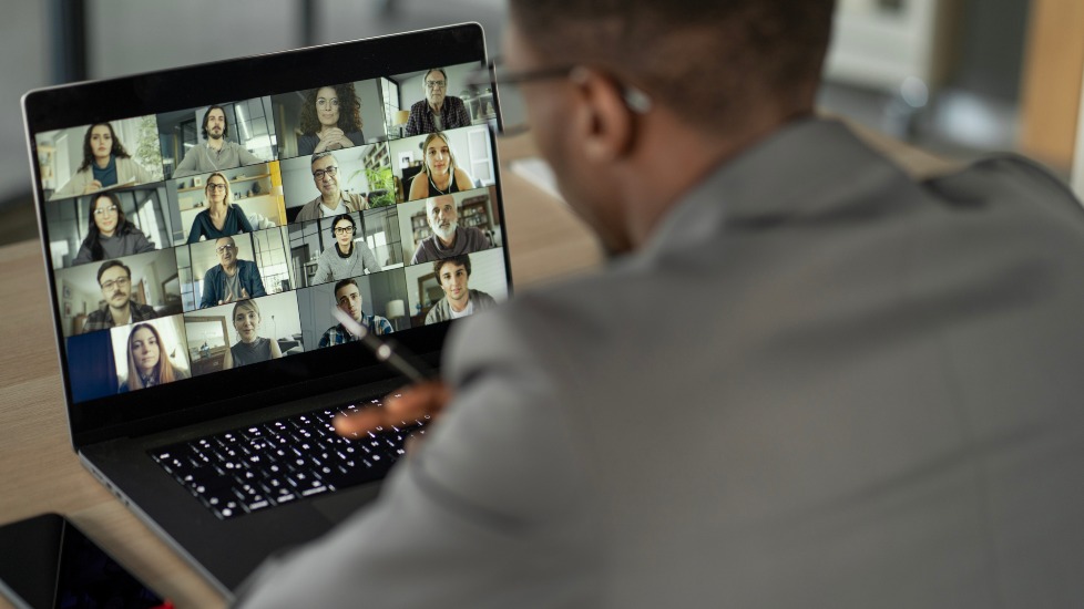 Man attending meeting on laptop
