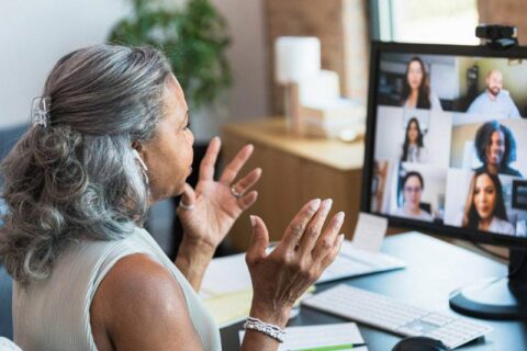 women attending meeting on laptop
