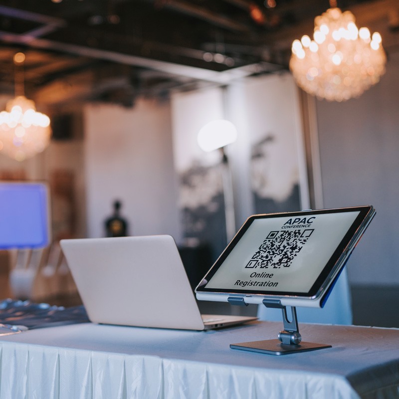 A laptop and a QR code for online registration on a table in Denver, Colorado.