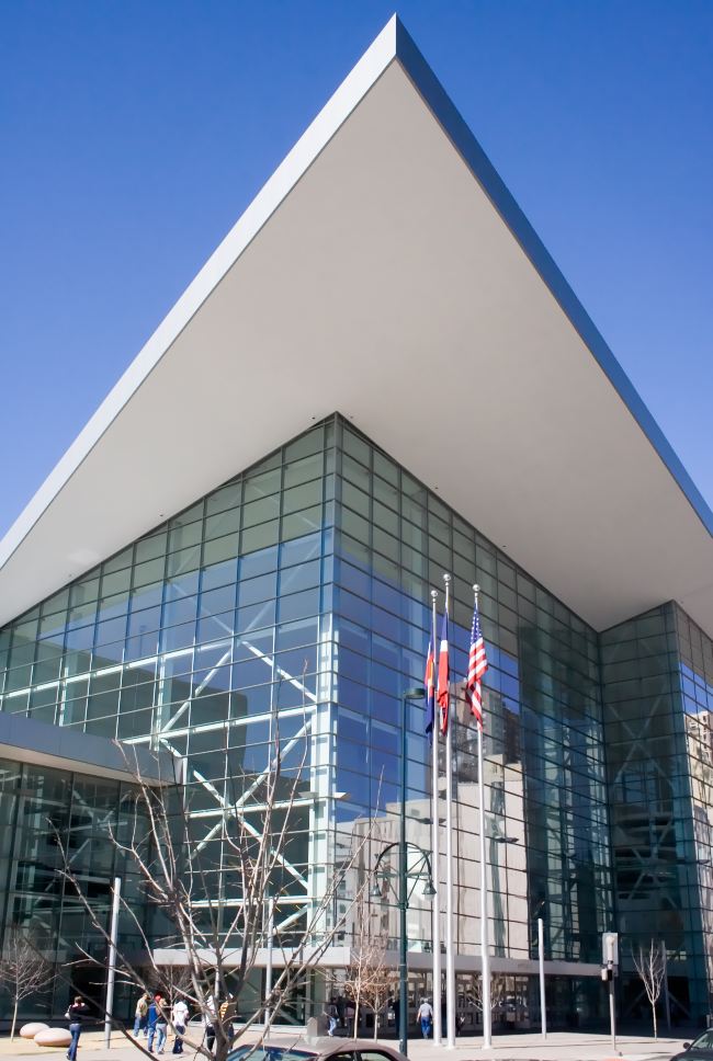 Colorado Convention Center in Denver, CO with a clear blue sky background