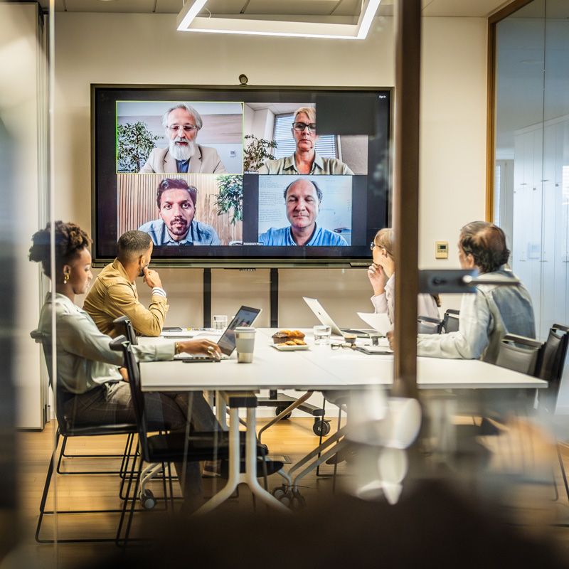 People in a conference room having a virtual meeting in Denver, CO