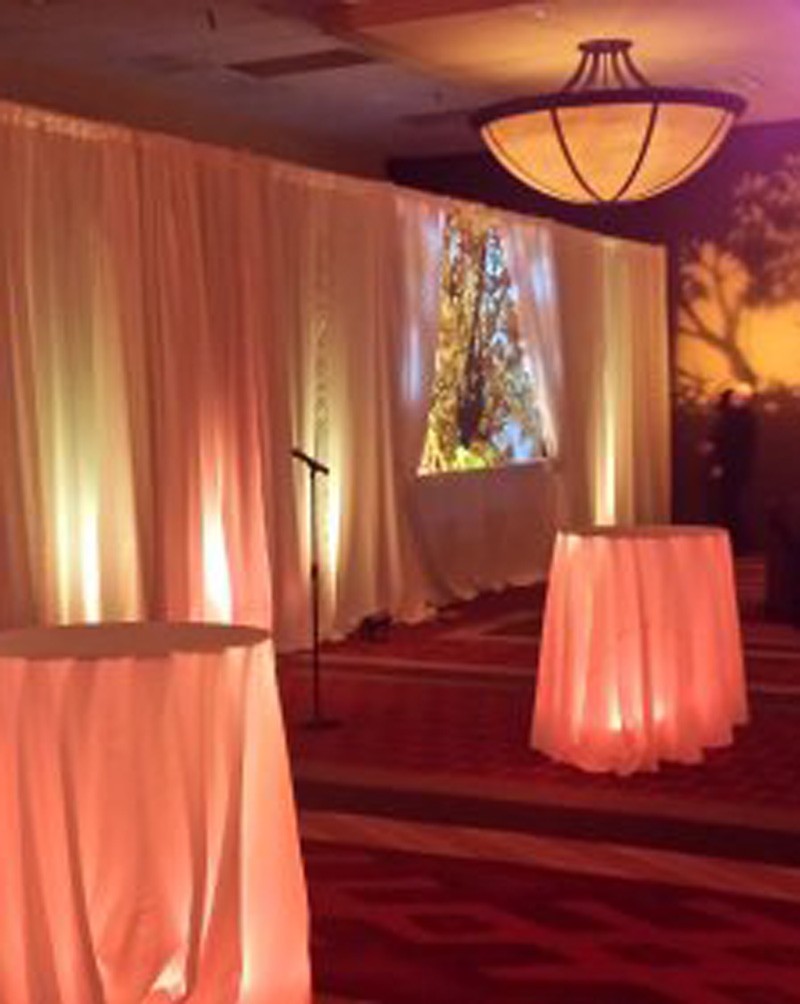 Event space with glowing tables and a mic for translation systems conference in Denver, CO