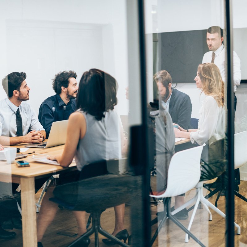 Business meeting using a conference and translation system in a modern office in Denver, CO