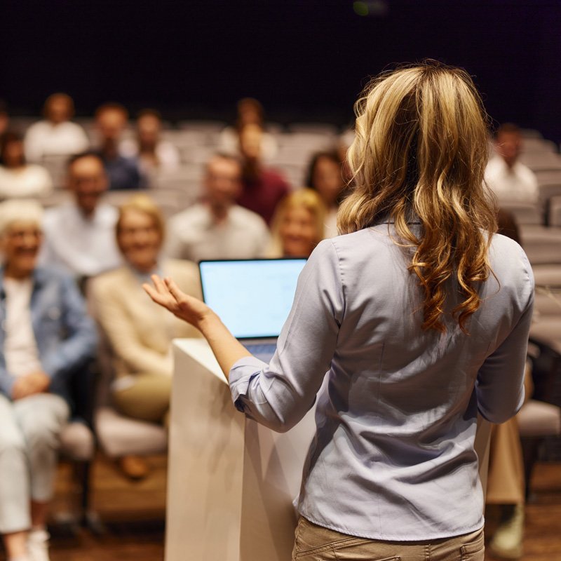 A woman speaker using AV equipment for a special event by Spectrum Audio Visual in Denver, CO