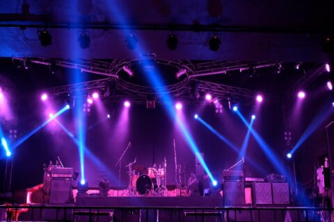 A concert stage with purple & blue lights, showcasing event production trends in Denver, CO