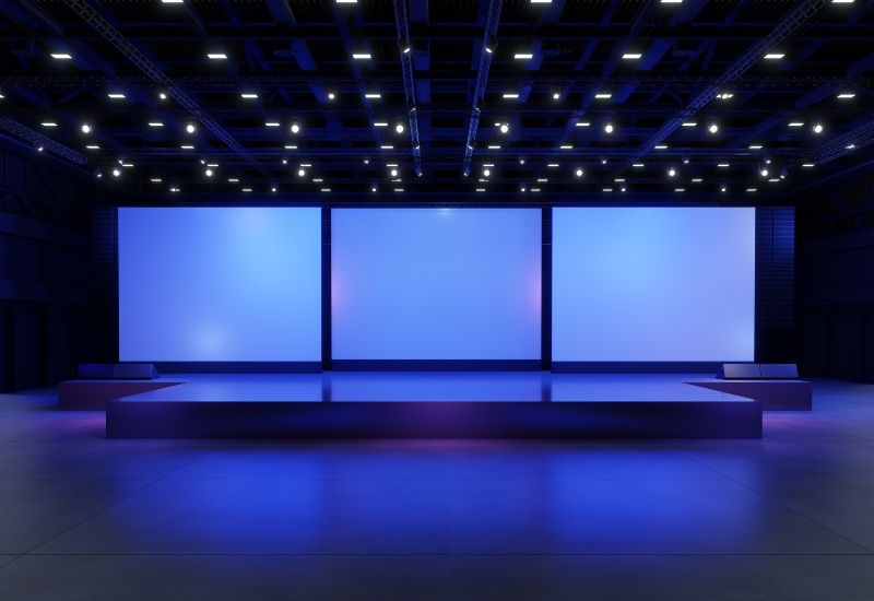 A modern stage with three large blue screens, featuring the project screen size in Denver, CO